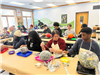Volunteers work on a nature craft together