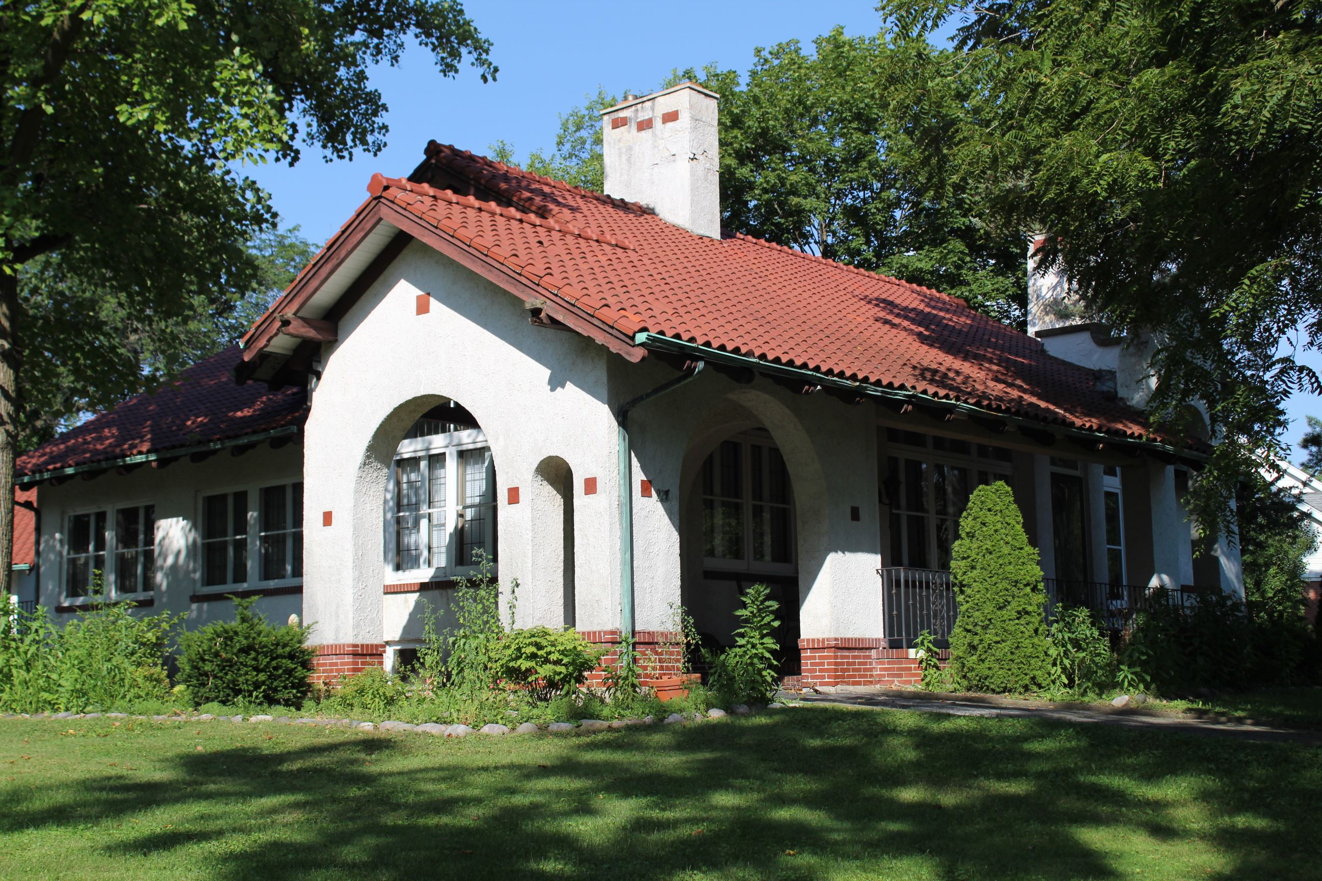 Photo of Historic Home with White Stucco Exterior and Red Clay Roof Tiles
